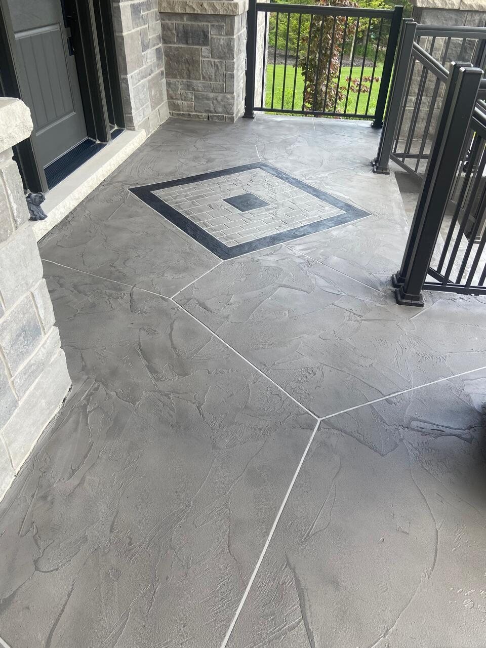 Finished decorative porch with black metal railings